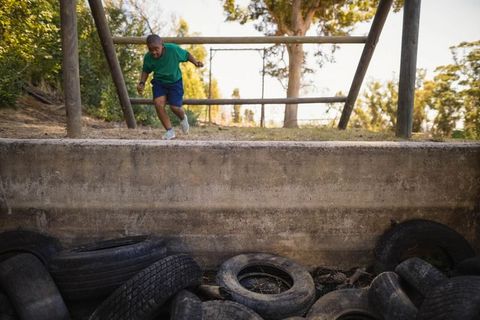 Child enjoying outdoor obstacle course with tire challenge