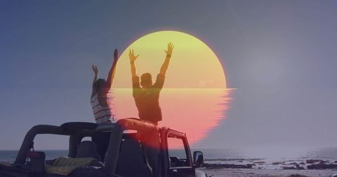 Two Men Celebrating Sunset Adventure on Rocky Beach