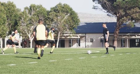 Soccer Players Practicing Teamwork on Sunny Field