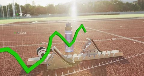 Sprint starting blocks with performance graph overlay at sunset track