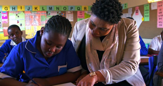 Teacher Helping Student with Schoolwork in Classroom - Download Free Stock Images Pikwizard.com