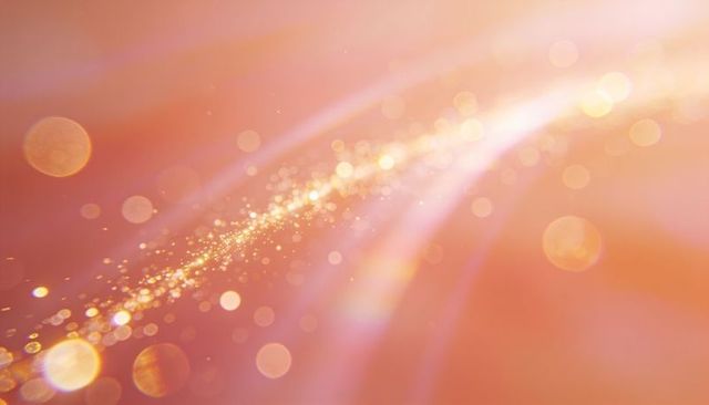 Ethereal peach-pink light trail with glitter bokeh and soft glow