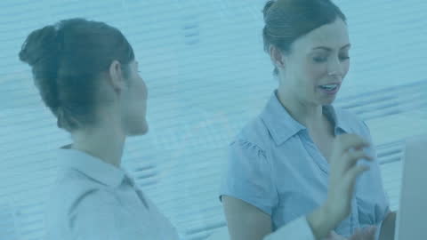 Modern Businesswomen Discussing in Technology-Driven Office