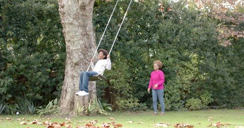 Mother and Son Enjoy Tree Swing Playtime in Backyard - Download Free Stock Images Pikwizard.com