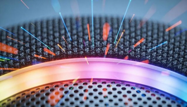 Glowing smart speaker rgb ring with knit top and perforated grille, neon streaks