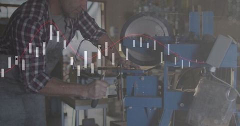 Machinist operating lathe in industrial workshop with financial overlay