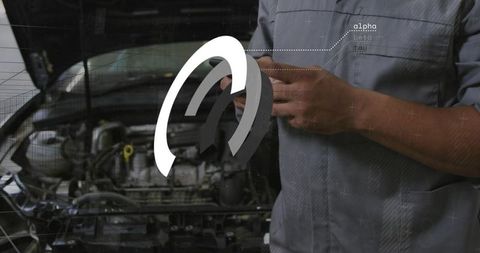 Mechanic Tapping Mobile Diagnostic App with Augmented Reality Overlay on Open Car Engine