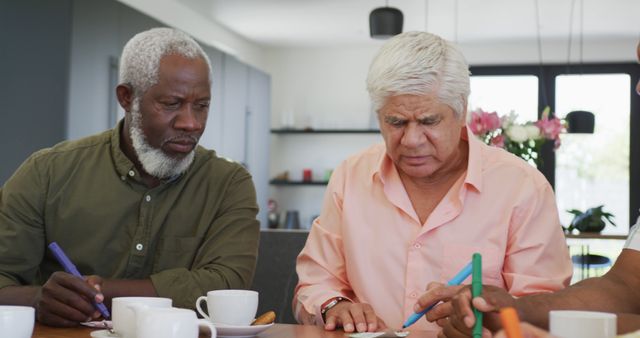 Senior Men Engaged in Creative Drawing Activity at Café - Download Free Stock Images Pikwizard.com