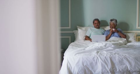 Senior Couple Enjoying Relaxing Time in Bed with Laptop - Download Free Stock Images Pikwizard.com