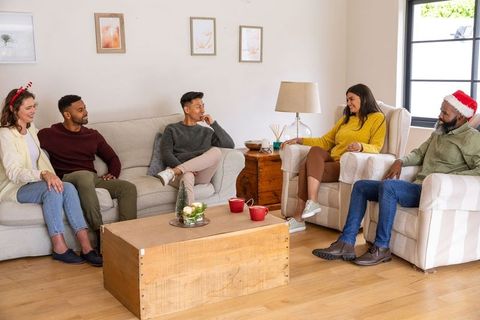 Friends Enjoying Festive Gathering in Cozy Living Room