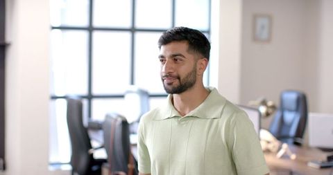 Smiling professional engaged in office conversatio