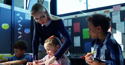 Friendly Female Teacher Assisting Diverse Classroom - Download Free Stock Images Pikwizard.com