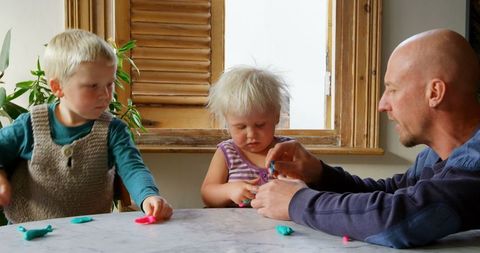 Father Bonding with Young Children Making Play Clay Creations at Home