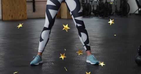 Female athlete standing in wide stance wearing patterned leggings and teal sneakers