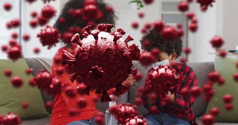 Mother and Son Wearing Masks Surrounded by Virus Cells
