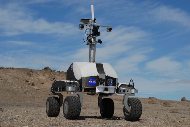 NASA's K-10 Rover operates with ground-penetrating radar in the polar desert environment of Haughton Crater, Devon Island, Nunavut. Studying Mars analog conditions, this image is ideal for use in educational materials on space exploration, robotics, environmental science, and geologic research, showcasing advanced technology in challenging environments.