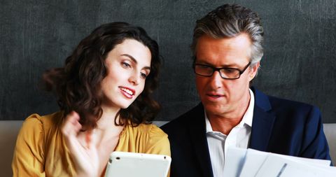 Professionals Discussing Business Plans in Restaurant Lounge