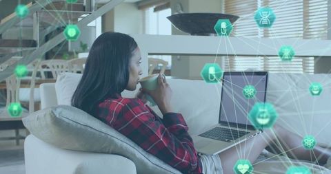 Woman Engaging with Digital Network on Laptop in Modern Living Space