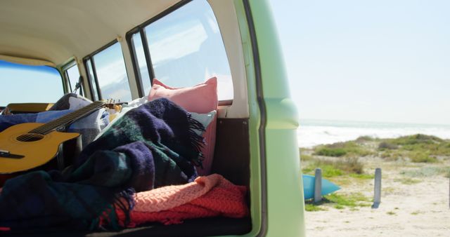 Guitar, cloths and blanket in van. Van at beach on a sunny day 4k
