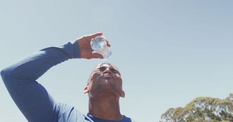 Fit Man Cooling Down with Water After Outdoor Workout
