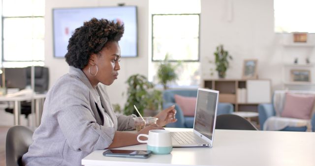 African American Businesswoman Having Lunch and Working on Laptop in Casual Office - Download Free Stock Images Pikwizard.com