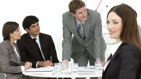Confident Businesswoman Smiling with Colleagues in Meeting