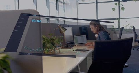 Finance analyst analyzing augmented reality financial dashboard at modern office workstation