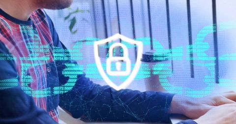 Typing chinese man securing laptop with holographic padlock shield and encryption overlay