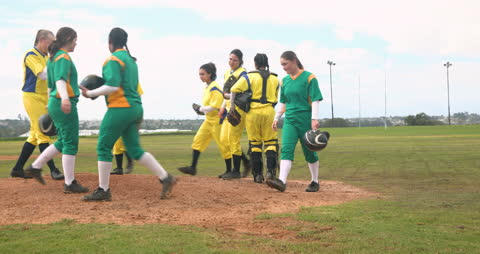 Female Baseball Players Rallying on Field in Colorful Uniforms