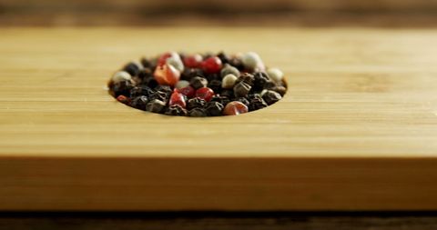 Colorful corn kernels on rustic wood surface with space