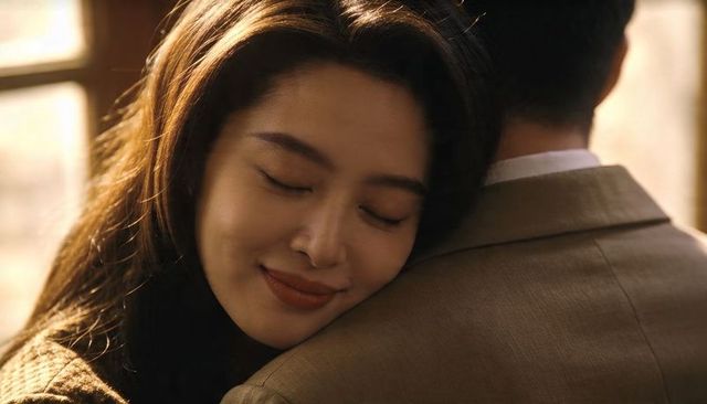 Sunlit intimate embrace with asian woman resting on partner's shoulder, warm romantic mood