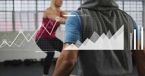 Fitness trainer monitoring client squat performance with digital analytics and strength tracking