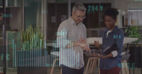 Diverse Colleagues Collaborating with Financial Data Insights in Office