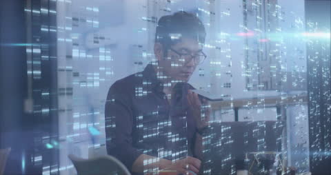 Asian Professional Engaging with Futuristic Digital Interface in Office