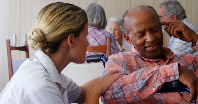 Nurse sits beside elderly man in nursing home, providing comfort and support. Both engaged in gentle conversation, conveying care and compassion. Ideal for illustrating concepts of elderly care, healthcare services, nursing home environments, and compassionate caregiving.