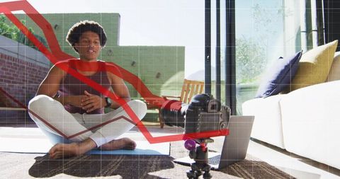 Recording yoga instructor teaching home workout with dslr, laptop and analytics overlay