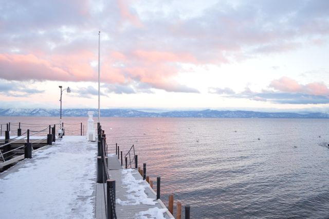 Serene Winter Lakefront with Snow and Pink Sunset Sky - Download Free Stock Photos Pikwizard.com