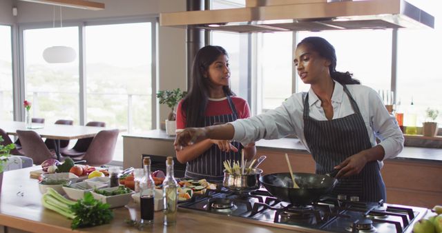 Image of happy diverse female friends preparing meal. Friendship, spending quality time together at home.