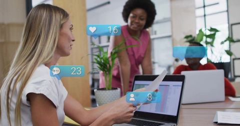 Businesswomen Collaborating in Modern Office with Social Media Icons