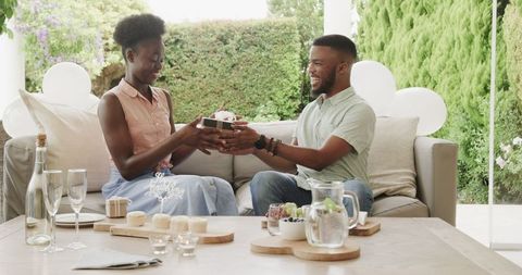 Happy Couple Exchanging Gifts in Outdoor Garden