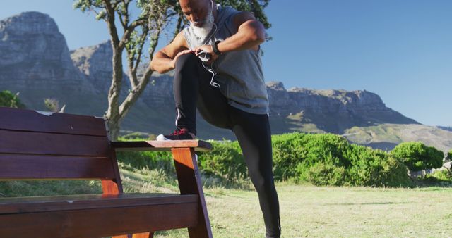 Active Mature Man Stretching and Checking Fitness Tracker in Outdoor Park - Download Free Stock Images Pikwizard.com