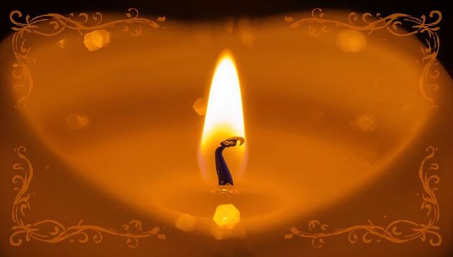 Amber candle flame macro with teardrop flame, charred wick, hexagon bokeh and ornate frame