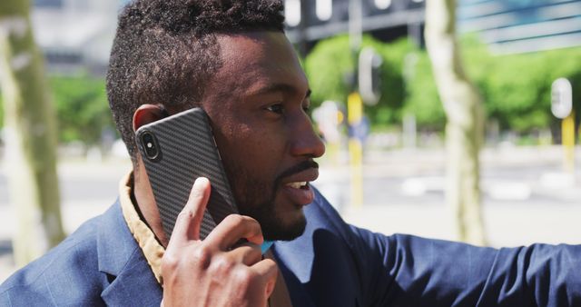 Young man talking on smartphone outdoors in casual attire - Download Free Stock Images Pikwizard.com