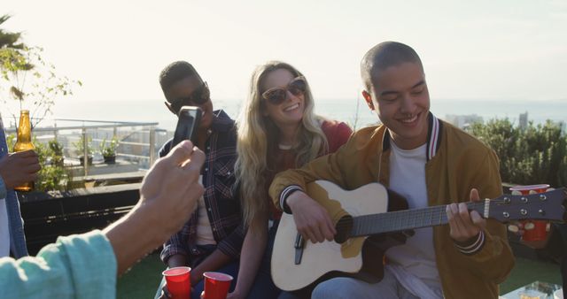 Diverse Friends Enjoying Rooftop Gathering with Music - Download Free Stock Images Pikwizard.com