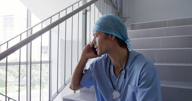 Medical Professional Taking Phone Call on Staircase - Download Free Stock Images Pikwizard.com