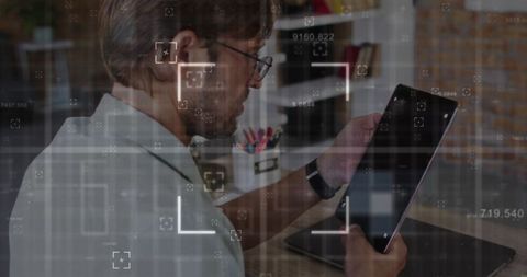 Middle-Aged Man Using Tablet in Home Office