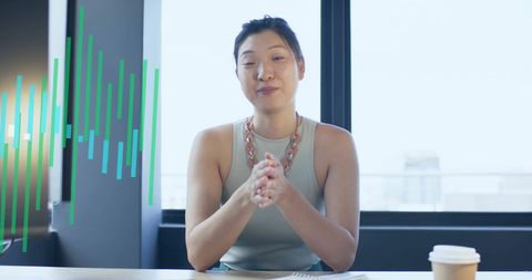 Asian Businesswoman Analyzing Financial Data in Modern Office