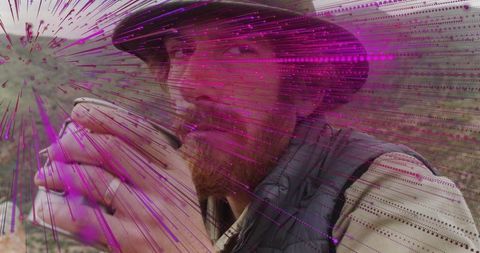 Bearded hiker sipping metal cup in bucket hat with magenta digital light streaks