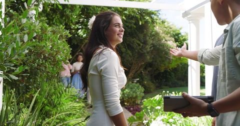 Bride in White Dress Gathering with Guests at Outdoor Celebration