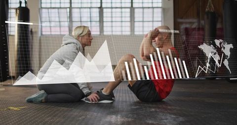 Trainer holding feet while client doing situps in gym with analytics overlay